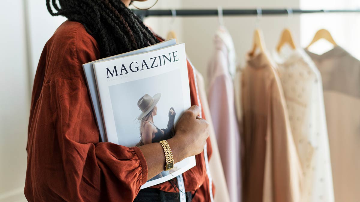 Entrepreneur holding a fashion magazine in creative studio – cover image for Famozzo Magazine, a digital publication for founders, creators, and leaders.